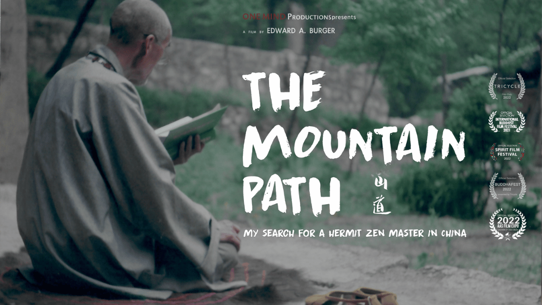 Flyer for a film festival advertising the documentary "The Mountain Path". The image shows a monk with his back toward the camera, seated reading.